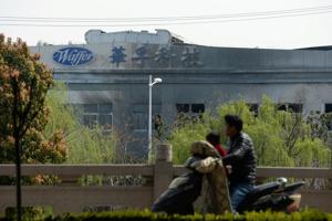 A man drives a motorbike past a damaged building of a metal-molding plant owned by Kunshan Waffer Technology Co following an explosion in Kunshan, Jiangsu province, China March 31, 2019.(REUTERS FILE PHOTO)