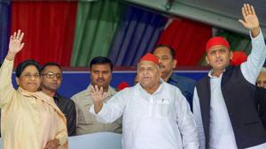Samajwadi Party patron Mulayam Singh Yadav, his son and party president Akhilesh Yadav and Bahujan Samaj Party supremo Mayawati wave at the crowd during their joint election campaign rally in Mainpuri on Friday.(PTI)