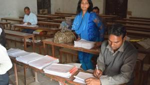 Teachers evaluating answer sheets at an evaluation centre in Prayagraj last month.(HT File) Teachers evaluating answer sheets at an evaluation centre in Prayagraj last month.(HT File)
