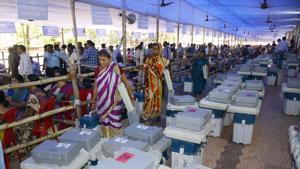Poling officials carry the Electronic Voting Machines (EVM) and Voter Verifiable Paper Audit Trails (VVPAT) from the collection centre ahead of the third phase of Lok Sabha elections and Odisha State Assembly polls, at BJB College, in Bhubaneswar on Sunday, April 21, 2019.(Arabinda Mahapatra /HT PHOTO)