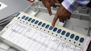 An Indian election official examines an Electronic Voting Machine (EVM) at a distribution centre ahead of the third phase of India's general election(AFP)