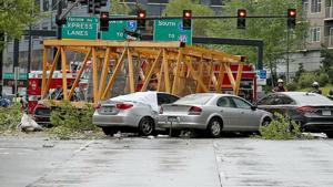 Four people were killed and three wounded when a construction crane collapsed Saturday in downtown Seattle, pinning five cars underneath.(AP) Four people were killed and three wounded when a construction crane collapsed Saturday in downtown Seattle, pinning five cars underneath.(AP)