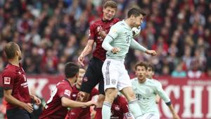 Bayern's Robert Lewandowski, top right, jumps for the ball with Nuremberg's Patrick Erras, top left.(AP) Bayern's Robert Lewandowski, top right, jumps for the ball with Nuremberg's Patrick Erras, top left.(AP)