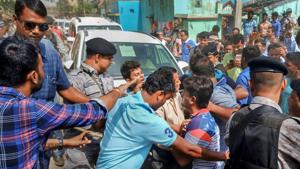 Security personnel make way for BJP candidate Babul Supriyo's SUV after it was allegedly attacked by the TMC supporters while he was heading towards a polling station, in Asansol on Monday.(PTI Photo)