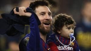Barcelona forward Lionel Messi holds his son as celebrates winning the Spanish League title.(AP) Barcelona forward Lionel Messi holds his son as celebrates winning the Spanish League title.(AP)