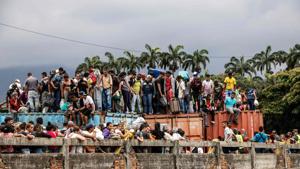 Venezuelans remain on top of containers as they attempt to cross the blocked Simon Bolivar international bridge, in Cucuta, Colombia, in the border with Venezuela.(AFP) Venezuelans remain on top of containers as they attempt to cross the blocked Simon Bolivar international bridge, in Cucuta, Colombia, in the border with Venezuela.(AFP)