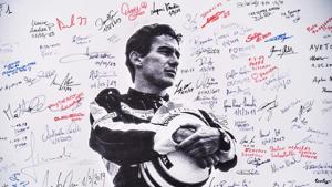 A poster bearing a photo of Brazilian's F1 driver Ayrton Senna signed by fans is displayed during a ceremony.(AFP) A poster bearing a photo of Brazilian's F1 driver Ayrton Senna signed by fans is displayed during a ceremony.(AFP)