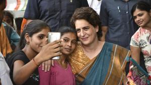 Congress General Secretary Priyanka Gandhi Vadra poses for a selfie with young supporters during an election campaign meeting for the Lok Sabha polls, in Amethi constituency, Tuesday, April 30, 2019.(PTI)