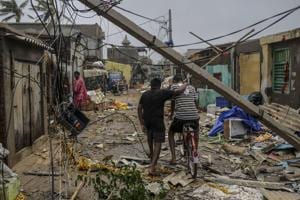 People walk underneath damaged electric cabling in Cyclone Fani passes in the Puri district of Odisha, India, on Saturday, May 4, 2019.(Bloomberg file photo) People walk underneath damaged electric cabling in Cyclone Fani passes in the Puri district of Odisha, India, on Saturday, May 4, 2019.(Bloomberg file photo)