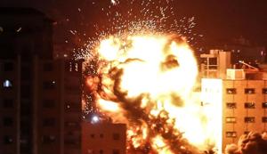 An explosion is pictured among buildings during an Israeli airstike on Gaza City on May 4, 2019.(AFP) An explosion is pictured among buildings during an Israeli airstike on Gaza City on May 4, 2019.(AFP)