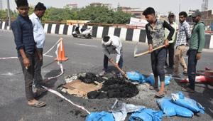 Workers repair a damaged portion of Hero Honda Chowk flyover. Workers repair a damaged portion of Hero Honda Chowk flyover.