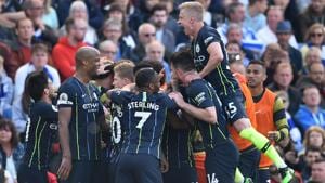 Manchester City players celebrate their third goal during the Premier League match against Brighton.(AFP)