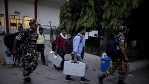 Election officers carry electronic voting machines at the end of polling in Prayagraj, Uttar Pradesh(AP) Election officers carry electronic voting machines at the end of polling in Prayagraj, Uttar Pradesh(AP)
