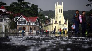 People take a stroll on the hail covered Ridge after hail storm on Wednesday evening, Shimla on Wednesday, May 01 2019.(Deepak Sansta / HT Photo)
