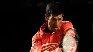 Novak Djokovic of Serbia returns the ball to Juan Martin Del Porto of Argentina.(AFP) Novak Djokovic of Serbia returns the ball to Juan Martin Del Porto of Argentina.(AFP)