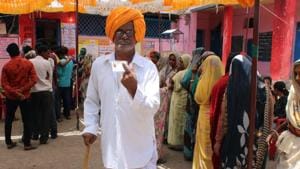 Madhya Pradesh, May 19 (ANI): Voter shows his ink-marked finger and voter ID card at a polling station after casting their vote at Rajod village in Dhar district in Madhya Pradesh on Sunday.(ANI) Madhya Pradesh, May 19 (ANI): Voter shows his ink-marked finger and voter ID card at a polling station after casting their vote at Rajod village in Dhar district in Madhya Pradesh on Sunday.(ANI)