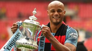 Manchester City's Belgian captain Vincent Kompany holds the winner's trophy after the English FA Cup final.(AFP)