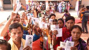 Voters show their identity cards as they stand in queues to cast their votes during the second phase of the general elections at a polling station, in Kandhamal district, Odisha, India, April 18, 2019.(HT PHOTO)