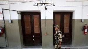 A security personnel keeps guard outside sealed strong rooms where electronic voting machines (EVM) are kept, in Ahmedabad, India, May 21, 2019.(REUTERS)