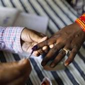 Lok Sabha election 2019: A polling officer puts indelible ink mark on the index finger of an women voter at a polling station, on the outskirts of Varanasi.(AP) Lok Sabha election 2019: A polling officer puts indelible ink mark on the index finger of an women voter at a polling station, on the outskirts of Varanasi.(AP)