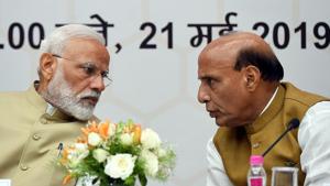 Bharatiya Janata Party (BJP) leader and Indian Prime Minister Narendra Modi (L) talks with Home Minister Rajnath Singh during a ceremony.(AFP)