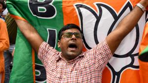 As part of the celebration, the supporters at central BJP headquarters were carrying party flags and wishing each other.(AFP File Photo) As part of the celebration, the supporters at central BJP headquarters were carrying party flags and wishing each other.(AFP File Photo)