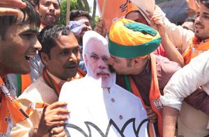 A Bharatiya Janata Party (BJP) supporter seen kissing a cut-out of Prime Minister Narendra Modi as they celebrate the party's lead on the counting day of 2019 Lok Sabha elections, at BJP office, in Jaipur.(Himanshu Vyas / Hindustan Times) A Bharatiya Janata Party (BJP) supporter seen kissing a cut-out of Prime Minister Narendra Modi as they celebrate the party's lead on the counting day of 2019 Lok Sabha elections, at BJP office, in Jaipur.(Himanshu Vyas / Hindustan Times)
