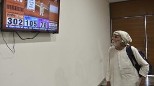 A BJP supporter watches the Lok Sabha election results on a television, in New Delhi, India.(Sanchit Khanna/HT PHOTO)