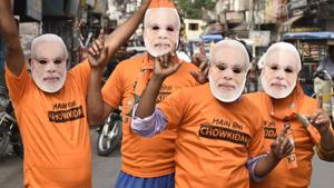 Bharatiya Janata Party (BJP) workers seen wearing Prime Minister Narendra Modi masks and ‘Chowkidaar’ T-shirts as National Democratic Alliance (NDA) takes lead in the Lok Sabha election results, in Amritsar, Punjab, India, on Thursday, May 23, 2019.(Sameer Sehgal/ Hindustan Times) Bharatiya Janata Party (BJP) workers seen wearing Prime Minister Narendra Modi masks and ‘Chowkidaar’ T-shirts as National Democratic Alliance (NDA) takes lead in the Lok Sabha election results, in Amritsar, Punjab, India, on Thursday, May 23, 2019.(Sameer Sehgal/ Hindustan Times)