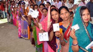 Voters show their ID cards as they wait in a queue to cast vote at a polling station.(ANI Photo) Voters show their ID cards as they wait in a queue to cast vote at a polling station.(ANI Photo)