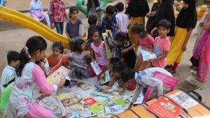 Thane, India - May.25,2019:Children in Mumbra gather excitedly at parks and gardens to read from the suitcase library initiative ,India, on Saturday, May 25, 2019. ( Praful Gangurde/ HT Photo) Thane, India - May.25,2019:Children in Mumbra gather excitedly at parks and gardens to read from the suitcase library initiative ,India, on Saturday, May 25, 2019. ( Praful Gangurde/ HT Photo)