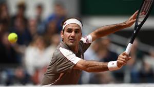 Switzerland's Roger Federer returns the ball to Italy's Lorenzo Sonego during their men's singles first round match on day 1 of The Roland Garros 2019 French Open tennis tournament in Paris on May 26, 2019(AFP) Switzerland's Roger Federer returns the ball to Italy's Lorenzo Sonego during their men's singles first round match on day 1 of The Roland Garros 2019 French Open tennis tournament in Paris on May 26, 2019(AFP)