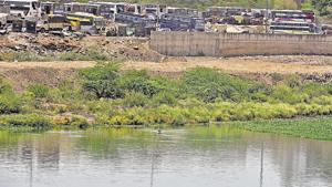 Civic activists say that the land near river at Sangamwadi, reclaimed by filling it with debris, is used for various purposes, including parking of luxury buses.(Pratham Gokhale/HT Photo) Civic activists say that the land near river at Sangamwadi, reclaimed by filling it with debris, is used for various purposes, including parking of luxury buses.(Pratham Gokhale/HT Photo)