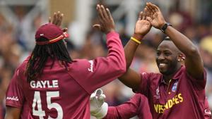 West Indies' Andre Russell (R) celebrates with West Indies' Chris Gayle (L) after taking a wicket.(AFP) West Indies' Andre Russell (R) celebrates with West Indies' Chris Gayle (L) after taking a wicket.(AFP)