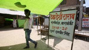 A man walks past the local liquor shop at Raniganj Village in Barabanki district.(ANI) A man walks past the local liquor shop at Raniganj Village in Barabanki district.(ANI)