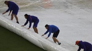 Ground staff roll out rain covers on the pitch after rain stopped play during the ICC World Cup match between South Africa and West Indies.(AP) Ground staff roll out rain covers on the pitch after rain stopped play during the ICC World Cup match between South Africa and West Indies.(AP)