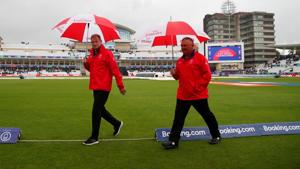 Umpires Marais Erasmus and Paul Reiffel after inspecting the pitch during a rain delay. Umpires Marais Erasmus and Paul Reiffel after inspecting the pitch during a rain delay.