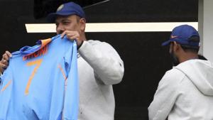 India's coach Ravi Shastri holds MS Dhoni team's jersey whilst standing in the players pavilion.(PTI) India's coach Ravi Shastri holds MS Dhoni team's jersey whilst standing in the players pavilion.(PTI)