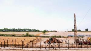 Heavy machines at work beyond the border fence for the construction of the Indian side of Kartarpur corridor, in Gurdaspur district, Monday.(PTI Photo)