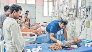 A doctor treats a child with Acute Encephalitis Syndrome (AES)-like symptoms at Patna Medical College and Hospital on June 17. A doctor treats a child with Acute Encephalitis Syndrome (AES)-like symptoms at Patna Medical College and Hospital on June 17.