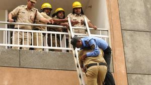 Firefighters carry a man during the mock rescue operation exercise, at Hope Apartment, Sector 15 , in Gurugram.(Parveen Kumar / Hindustan Times) Firefighters carry a man during the mock rescue operation exercise, at Hope Apartment, Sector 15 , in Gurugram.(Parveen Kumar / Hindustan Times)