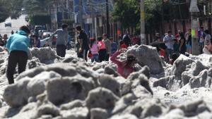 People are seen in a street of Guadalajara, Mexico, after a hail storm fell in the area.(AFP File Photo) People are seen in a street of Guadalajara, Mexico, after a hail storm fell in the area.(AFP File Photo)