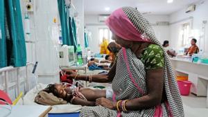 A relative sits next to a child patient who is suffering from acute encephalitis syndrome at a hospital in Muzaffarpur, Bihar, June 20, 2019.(Reuters) A relative sits next to a child patient who is suffering from acute encephalitis syndrome at a hospital in Muzaffarpur, Bihar, June 20, 2019.(Reuters)