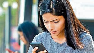 Beautiful woman holding drink can and text messaging on mobile phone Beautiful woman holding drink can and text messaging on mobile phone