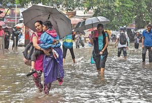 People wade through a flooded Sion on Monday.(Kunal Patil/HT Photo) People wade through a flooded Sion on Monday.(Kunal Patil/HT Photo)