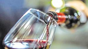 Unrecognizable person, holding a bottle of red wine, is pouring some red wine in a wine glass.(Getty Images) Unrecognizable person, holding a bottle of red wine, is pouring some red wine in a wine glass.(Getty Images)