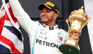 Mercedes' Lewis Hamilton with the trophy as he celebrates winning the race on the podium.(REUTERS) Mercedes' Lewis Hamilton with the trophy as he celebrates winning the race on the podium.(REUTERS)