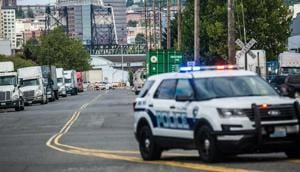 A police officer guards the front of a road block near the Northwest Detention Center(AP)