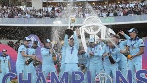 England's captain Eoin Morgan is sprayed with champagne as he raises the trophy after winning the Cricket World Cup.(AP) England's captain Eoin Morgan is sprayed with champagne as he raises the trophy after winning the Cricket World Cup.(AP)