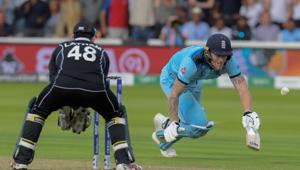 England's Ben Stokes (R) dives to make his ground and the ball hits him going for a boundary as New Zealand's Tom Latham looks on(AFP)